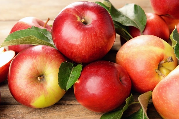 свежие красные яблоки с листвой
